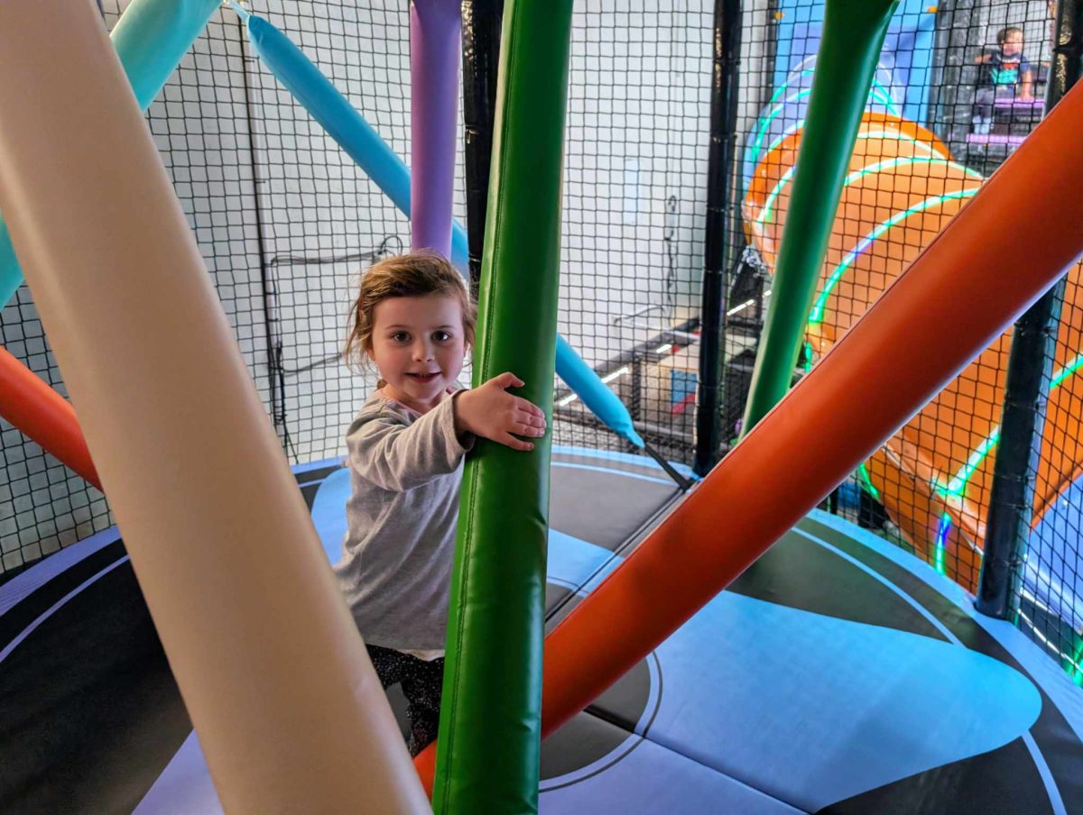 NEW Landing Play Centre Altona North 6 Child playing on a netted indoor obstacle course with padded poles and soft flooring at Landing Play Centre Altona North.