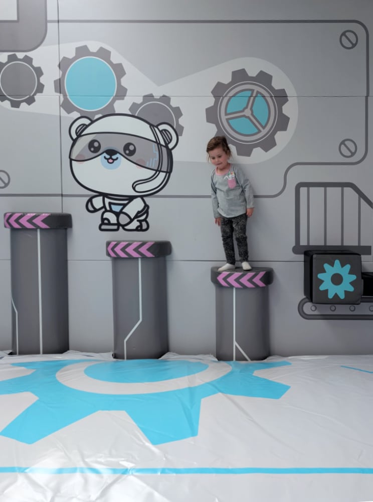 NEW Landing Play Centre Altona North 9 Child standing on padded stepping blocks above a soft landing mat in the space-themed play area at Landing Play Centre Altona North